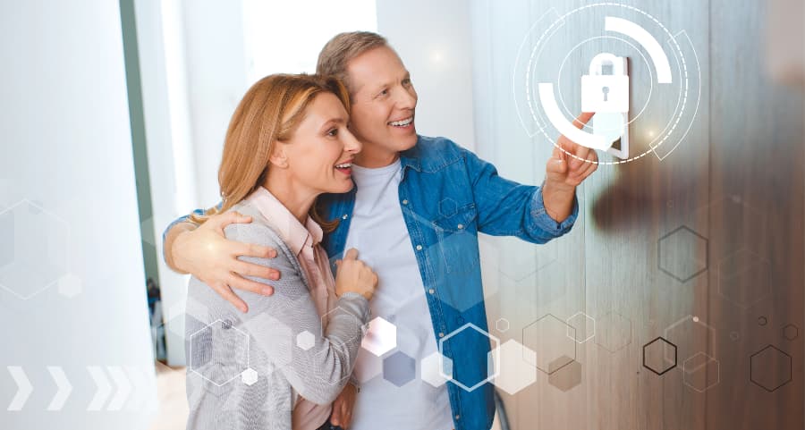 Happy couple interacting with a modern home security system